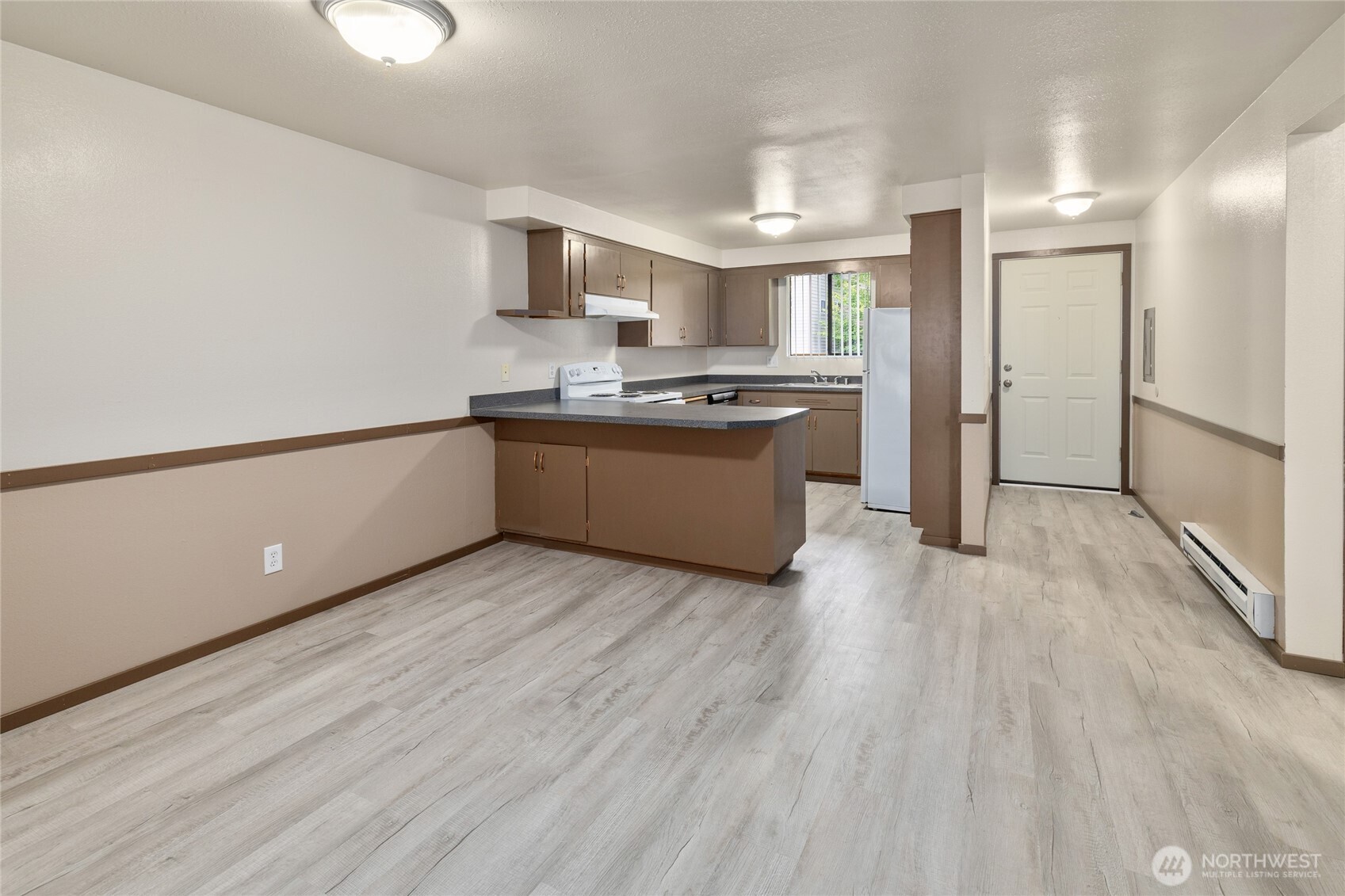 2517 Howard Avenue Everett, WA 98203 - Photo 3 of 32 a large kitchen with a wooden floor and stainless steel appliances