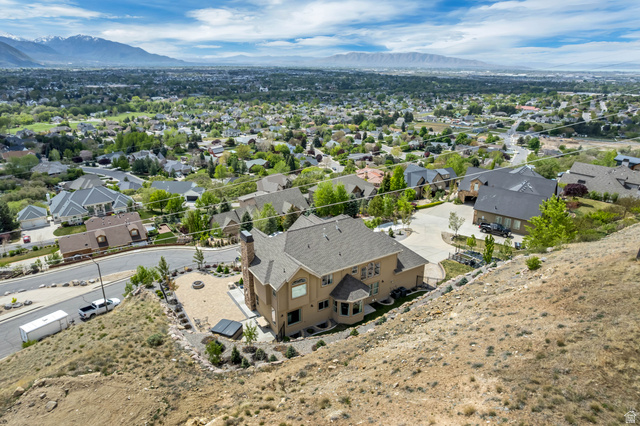 2543 East 700 South Springville, UT 84663 - Photo 64 of 73 Aerial view of residential area with property boundaries highlighted and a mountain backdrop