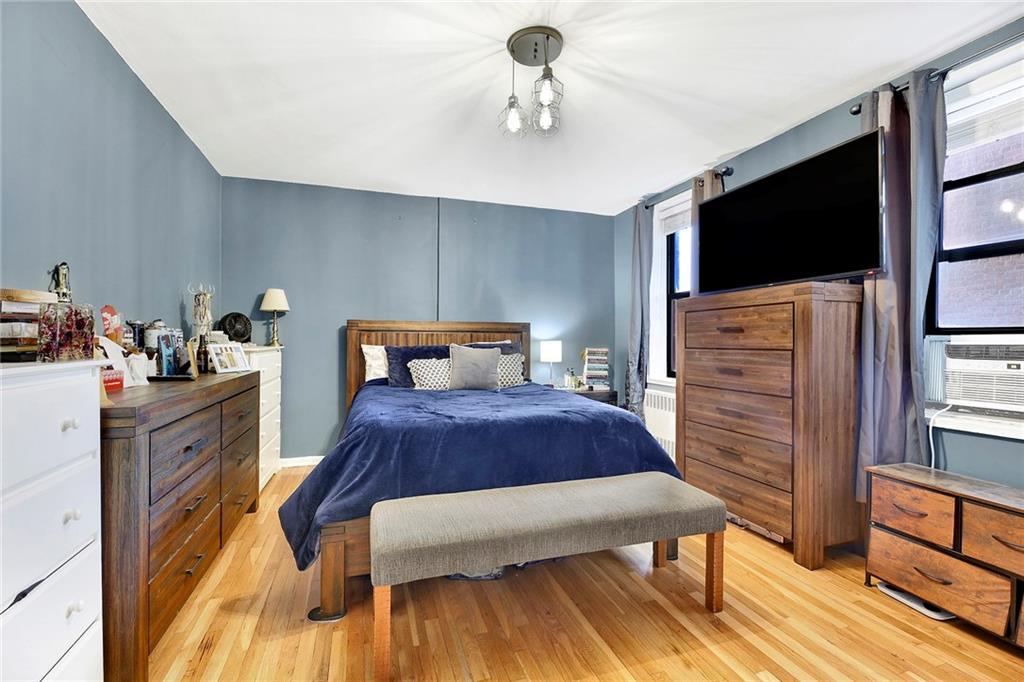 7259 Shore Road, Unit 2G Brooklyn, NY 11209 - Photo 11 of 16 a bedroom with a bed and flat screen tv