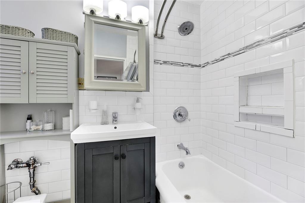7259 Shore Road, Unit 2G Brooklyn, NY 11209 - Photo 13 of 16 a bathroom with a sink and a bathtub