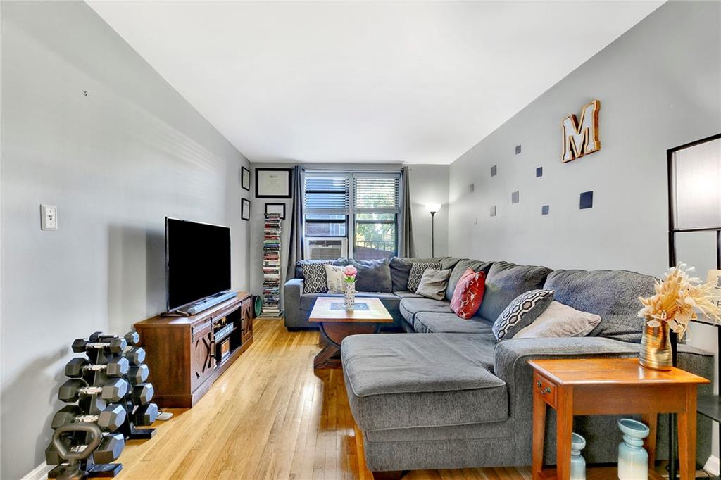 7259 Shore Road, Unit 2G Brooklyn, NY 11209 - Photo 7 of 16 a living room with furniture and a flat screen tv