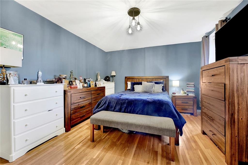 7259 Shore Road, Unit 2G Brooklyn, NY 11209 - Photo 10 of 16 a bedroom with a bed and a flat tv screen on wall