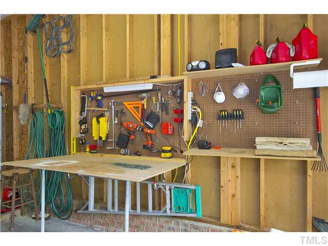 315 Catlin Road Cary, NC 27519 - Photo 25 of 25 Oversized garage has a fold up work bench....just unscrew the legs and lift the bench to hide your tools.