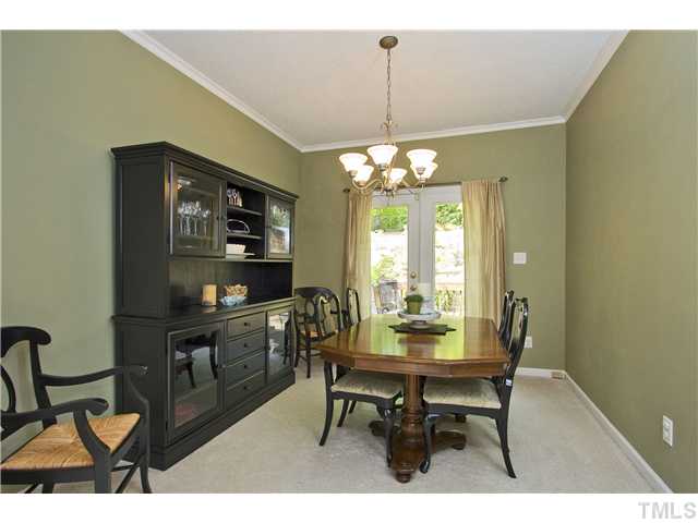 315 Catlin Road Cary, NC 27519 - Photo 9 of 25 Separate dining room with crown molding and door leading out to the deck