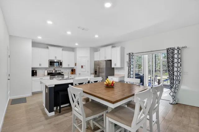 a kitchen with a table and chairs in it