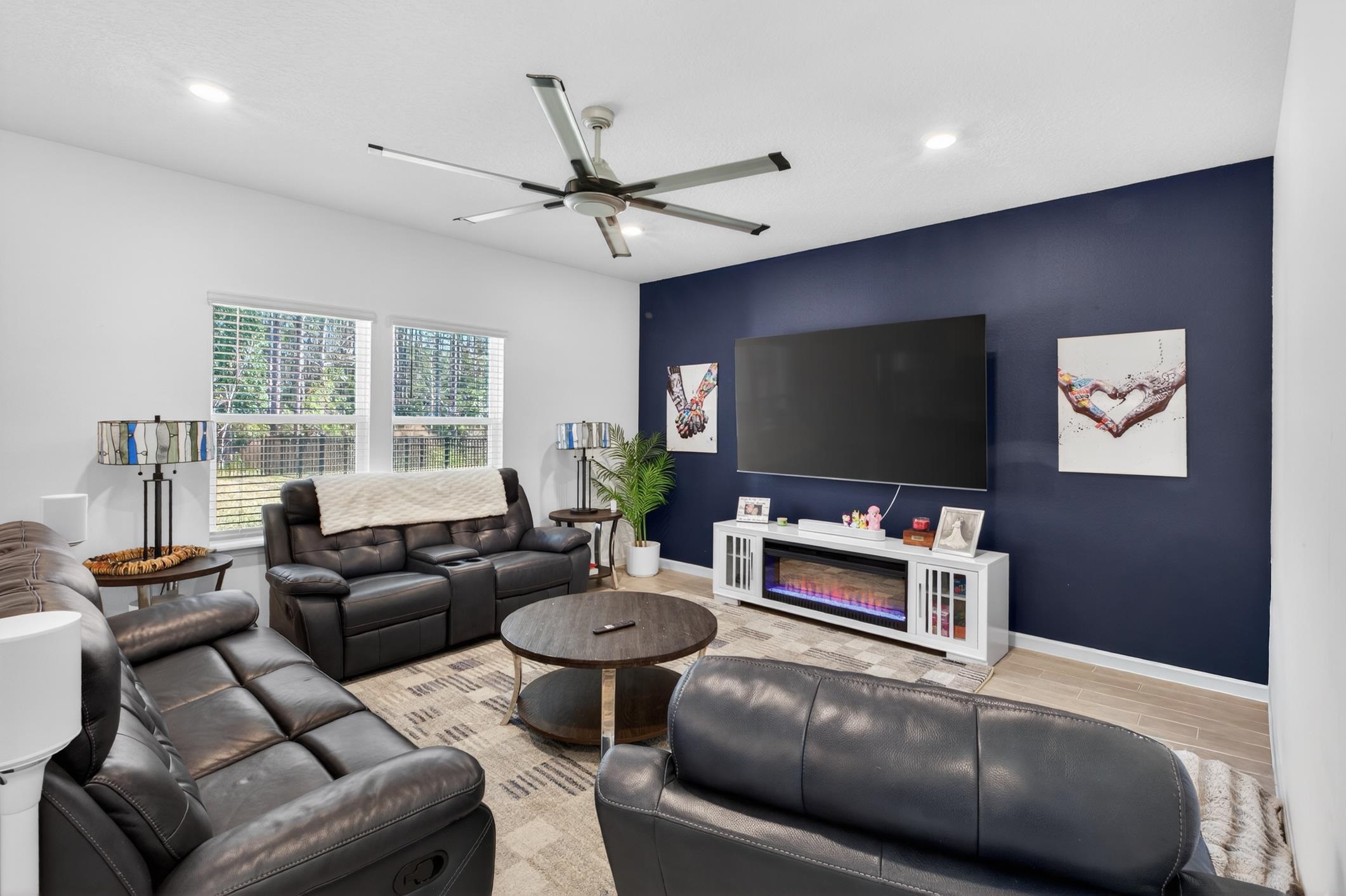 177 White Rabbit Run St. Augustine, FL 32092 - Photo 17 of 53 Living room featuring an accent wall, wood finish floors, a ceiling fan, and recessed lighting