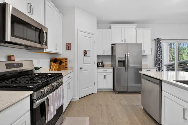 a kitchen with stainless steel appliances a refrigerator stove and sink