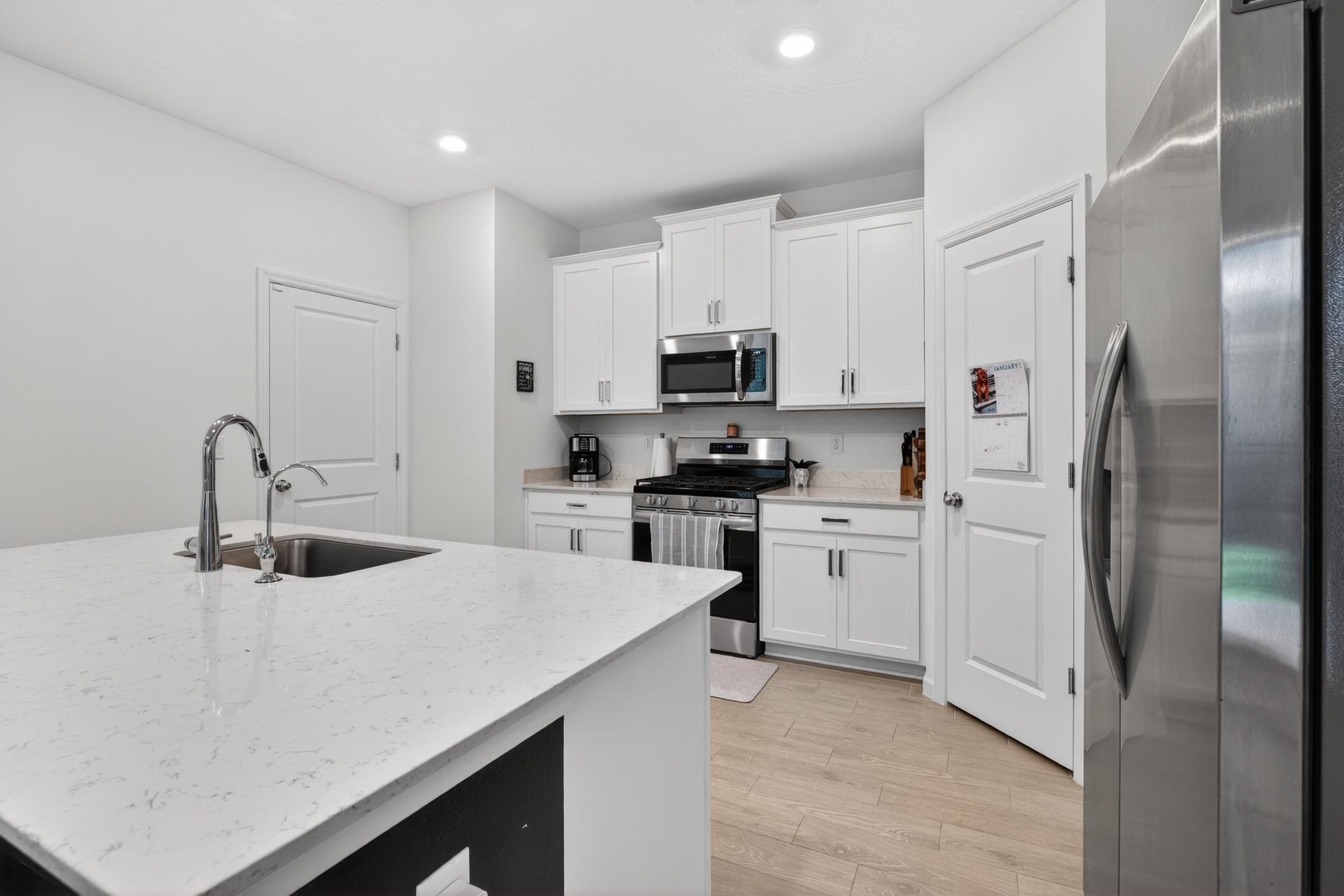 177 White Rabbit Run St. Augustine, FL 32092 - Photo 20 of 51 a kitchen with white cabinets and stainless steel appliances