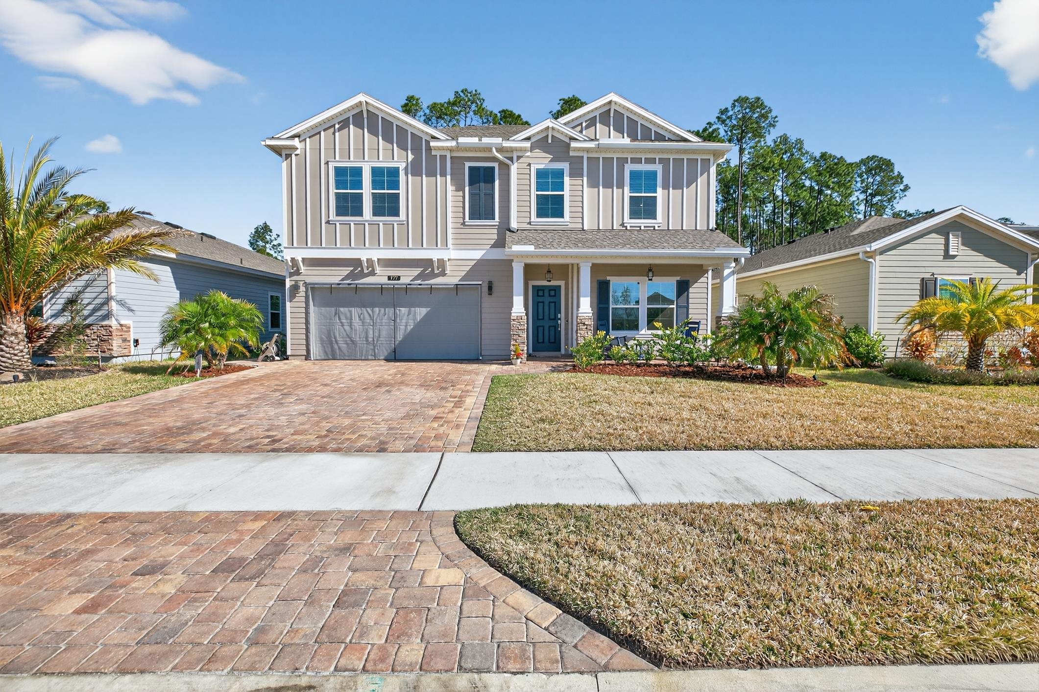 177 White Rabbit Run St. Augustine, FL 32092 - Photo 2 of 53 Craftsman inspired home featuring board and batten siding, an attached garage, covered porch, driveway, and a front yard