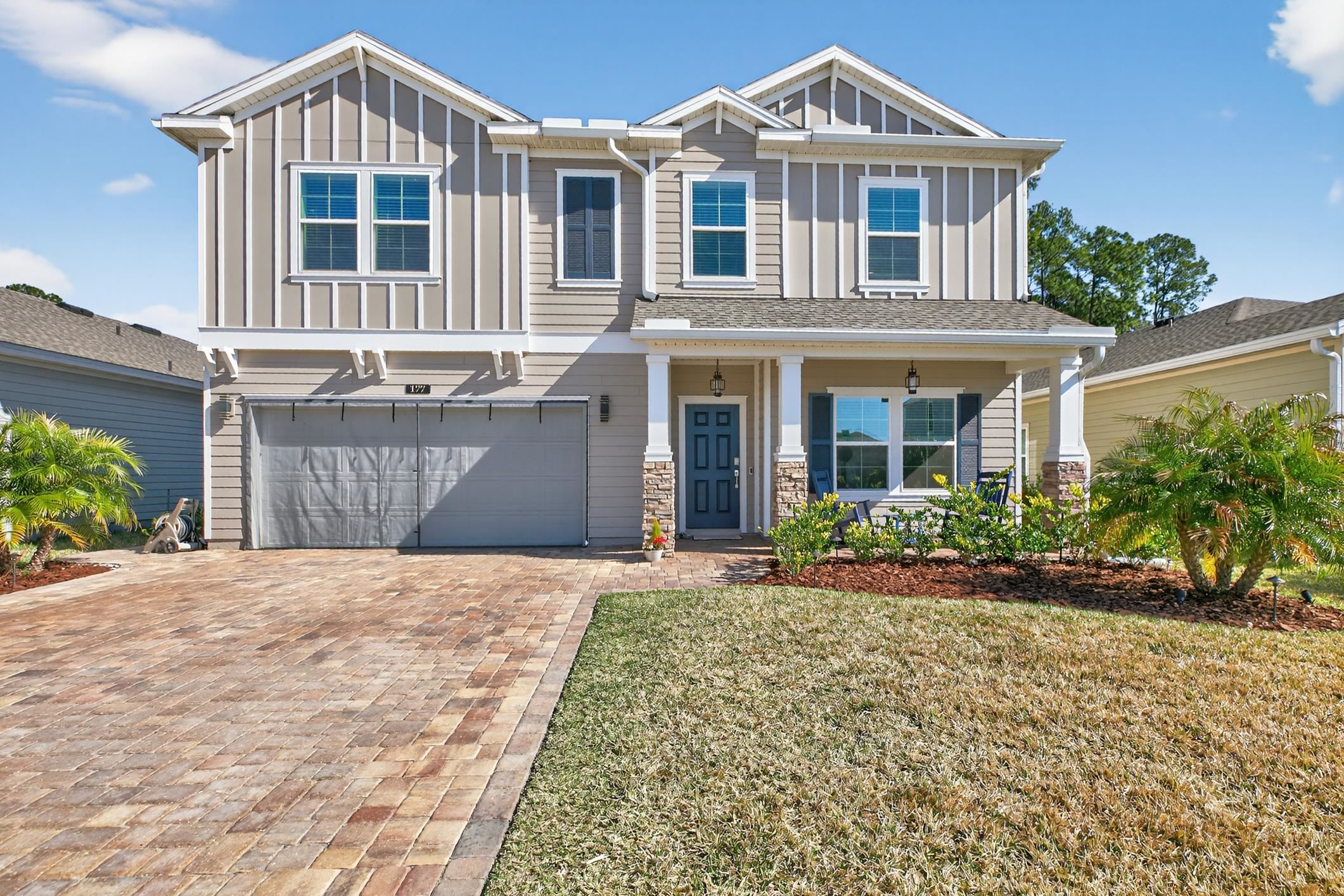 177 White Rabbit Run St. Augustine, FL 32092 - Photo 3 of 53 Craftsman house featuring board and batten siding, an attached garage, a porch, and driveway