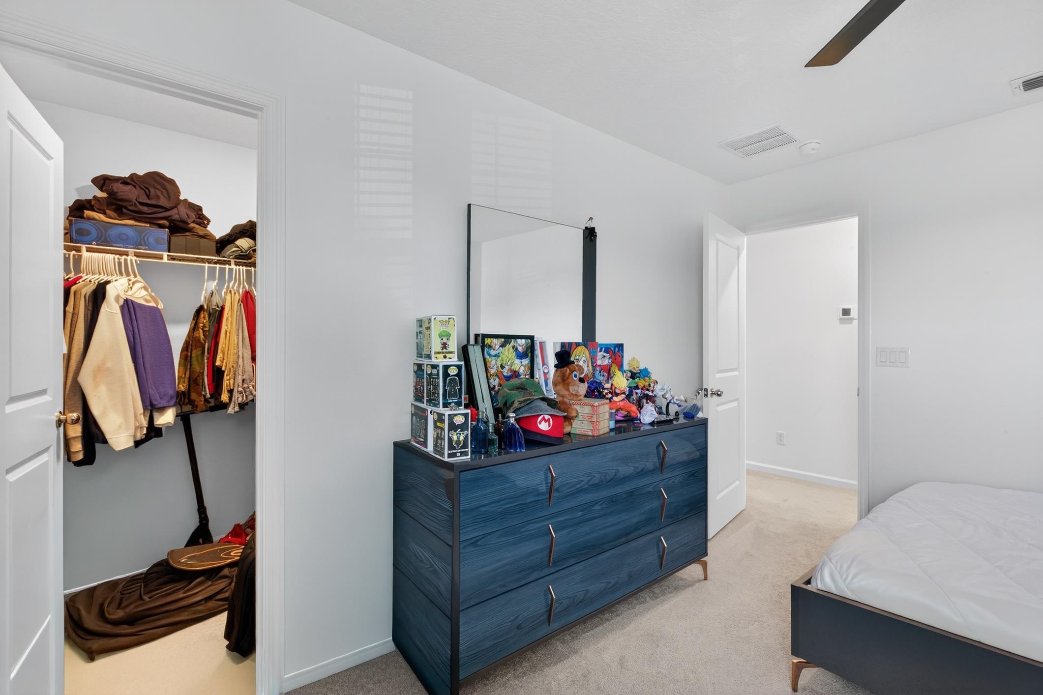 177 White Rabbit Run St. Augustine, FL 32092 - Photo 35 of 53 Bedroom with light colored carpet, a ceiling fan, and a spacious closet