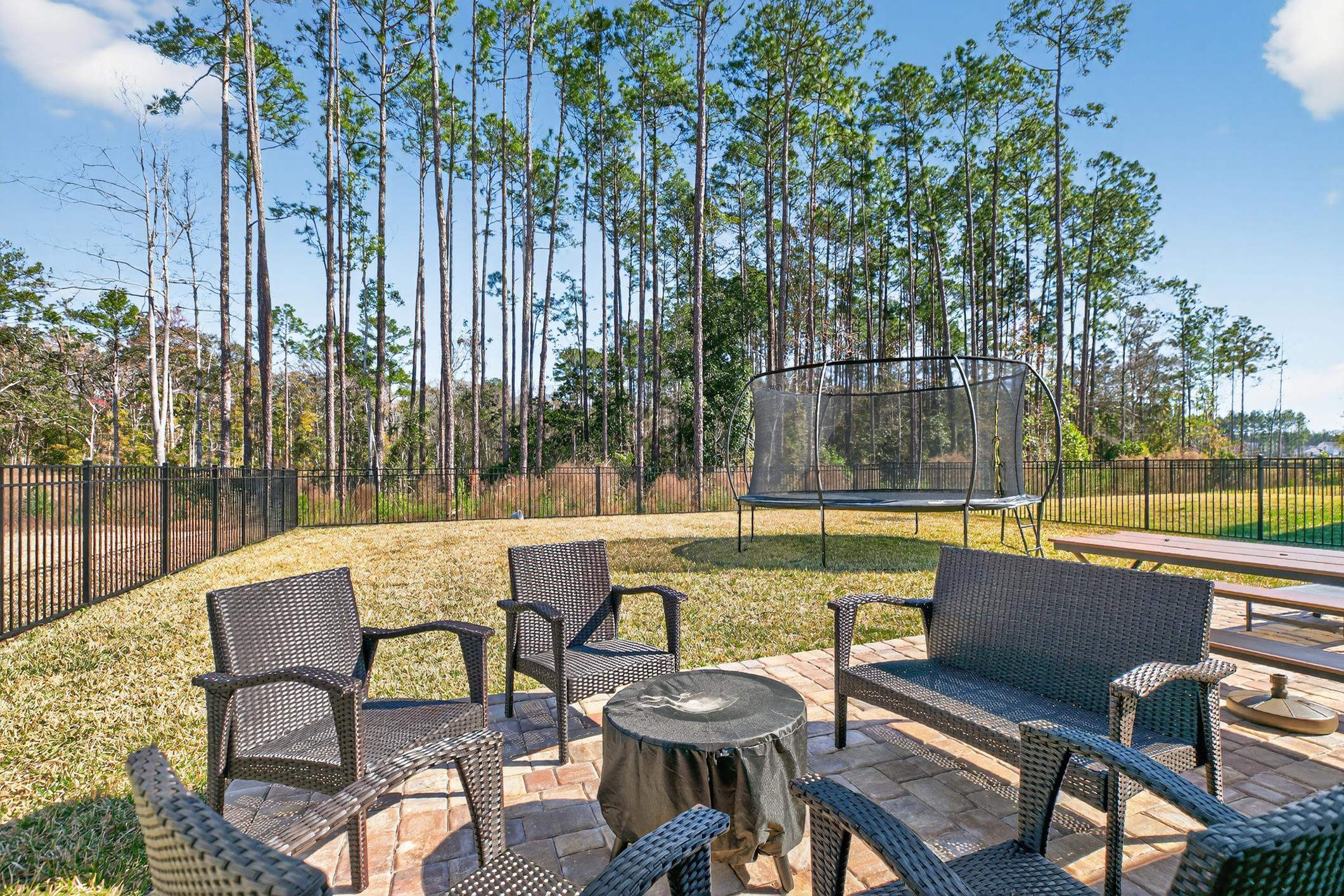 177 White Rabbit Run St. Augustine, FL 32092 - Photo 41 of 51 Fenced backyard with a trampoline, a patio area, and an outdoor living space