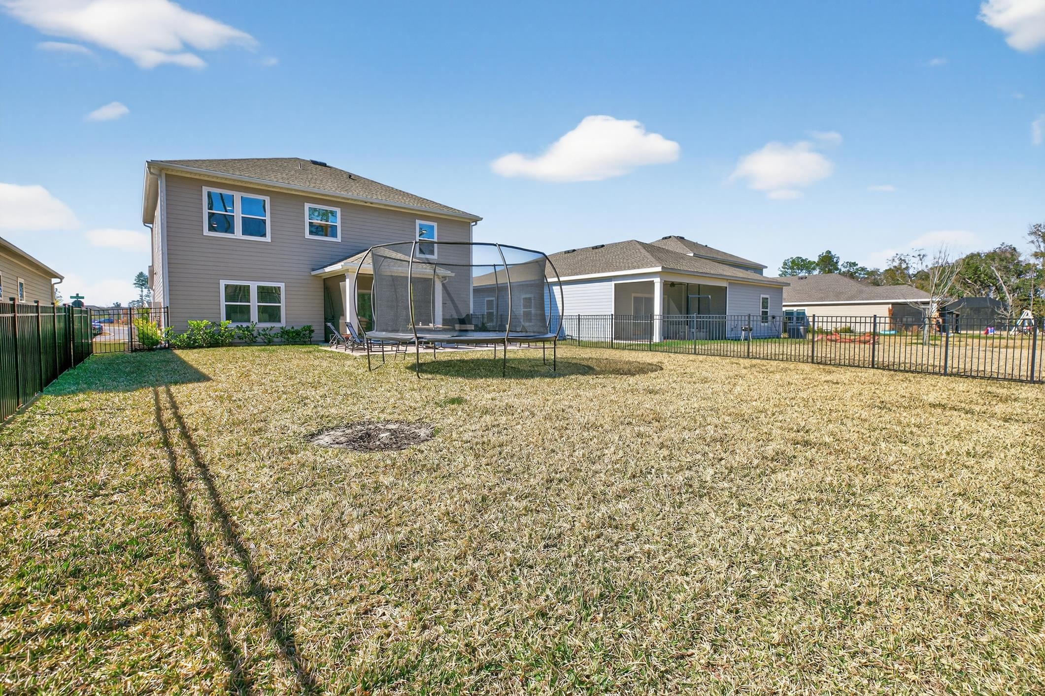 177 White Rabbit Run St. Augustine, FL 32092 - Photo 50 of 53 Rear view of house featuring a trampoline and a fenced backyard
