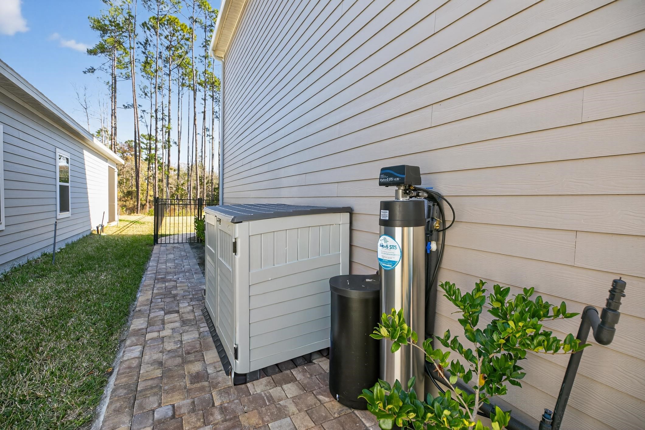 177 White Rabbit Run St. Augustine, FL 32092 - Photo 6 of 51 Exterior view of a water softener system and a gate