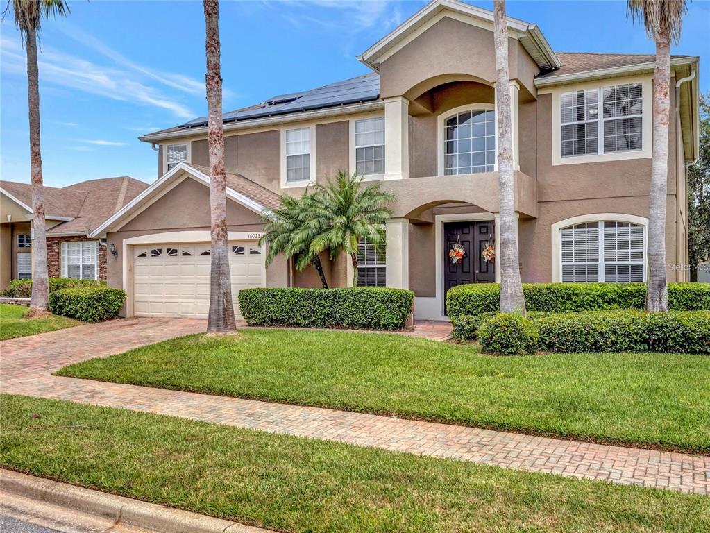 10023 Ians Ridge Road Orlando, FL 32832 - Photo 47 of 60 a front view of a house with a yard