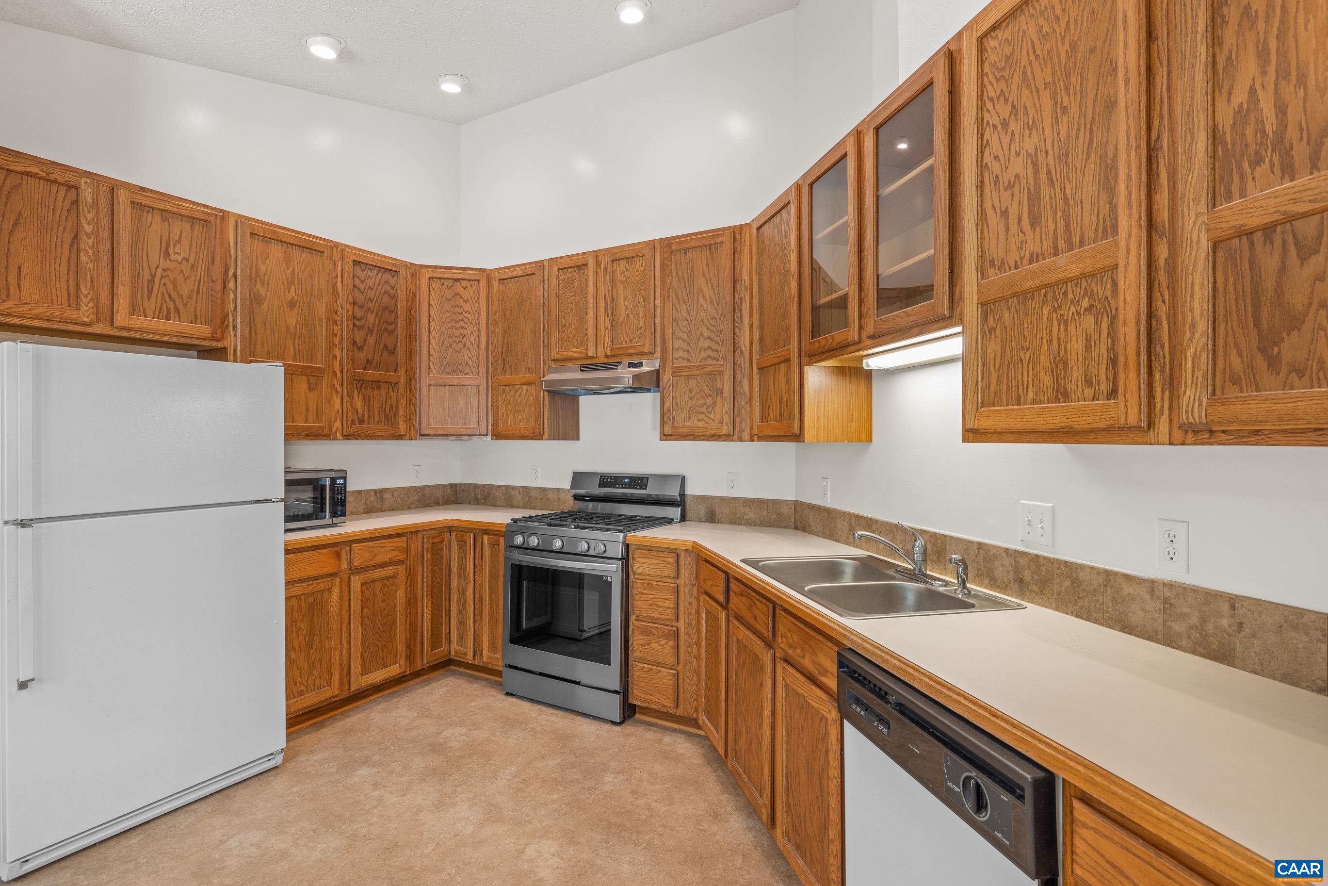 90 Riverside Drive Palmyra, VA 22963 - Photo 18 of 30 a kitchen with stainless steel appliances granite countertop a sink stove and refrigerator