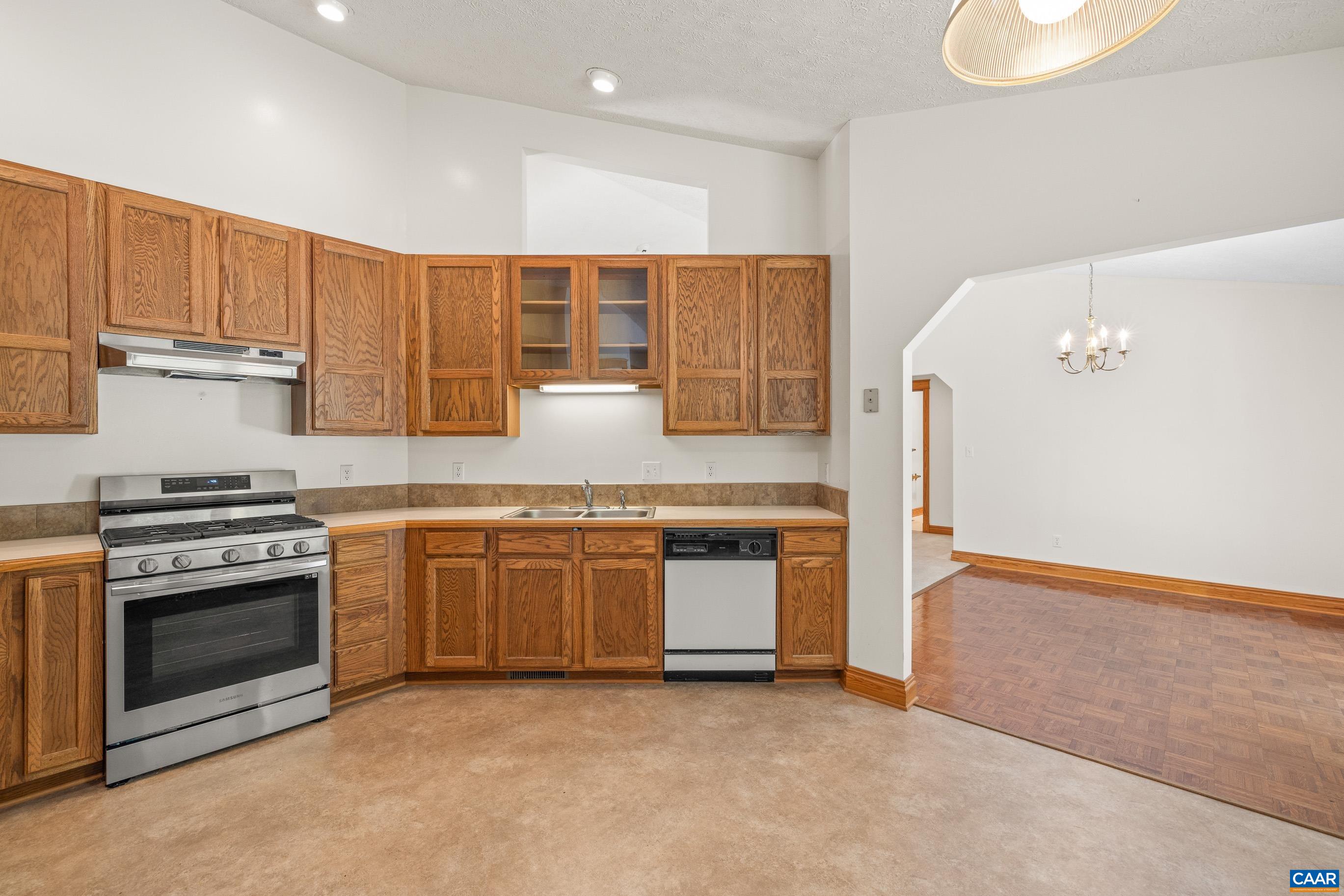 90 Riverside Drive Palmyra, VA 22963 - Photo 19 of 30 a kitchen with stainless steel appliances granite countertop a stove a sink and a refrigerator