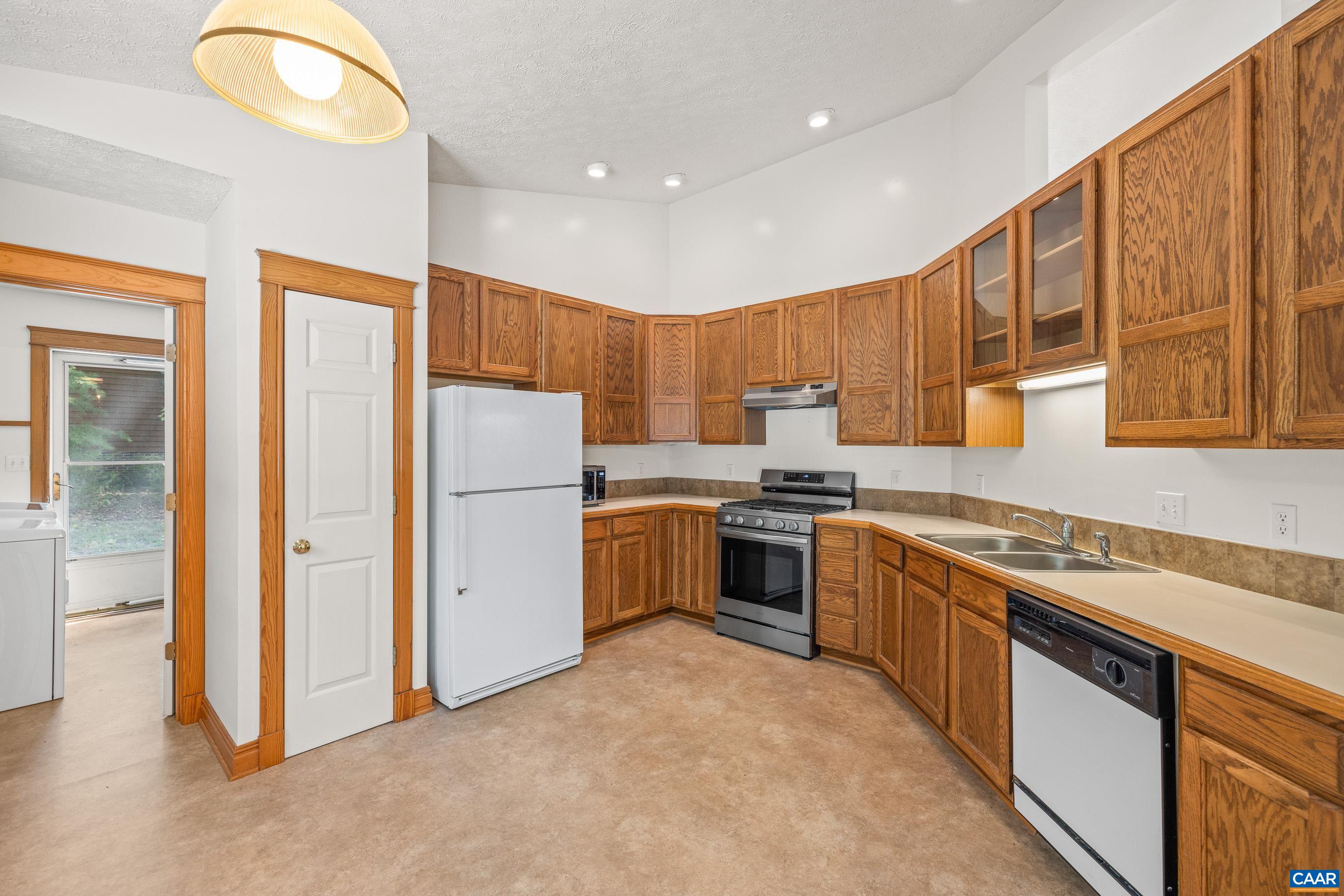 90 Riverside Drive Palmyra, VA 22963 - Photo 5 of 30 a kitchen with a sink a stove and a refrigerator