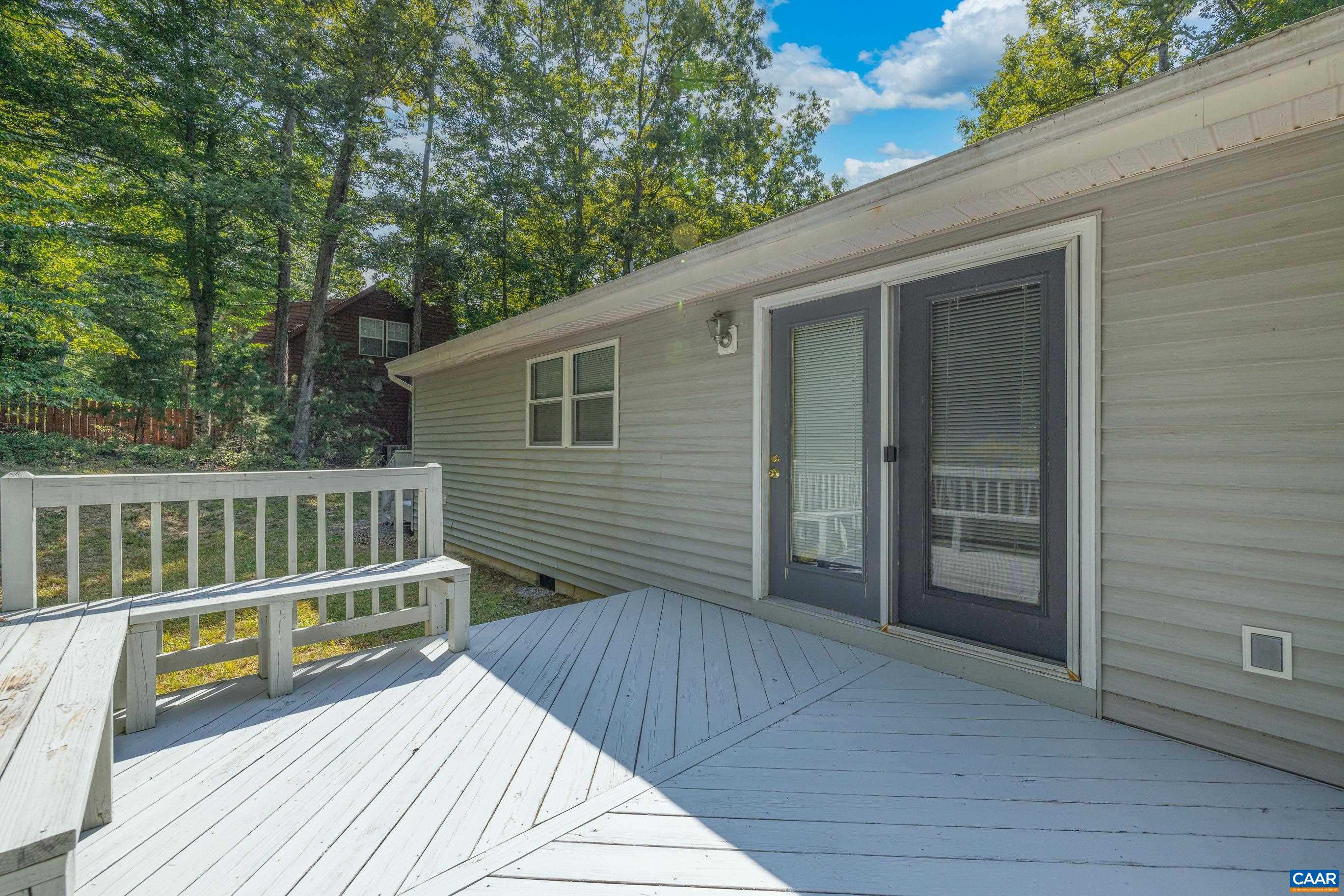 90 Riverside Drive Palmyra, VA 22963 - Photo 9 of 30 a view of a wooden deck and a yard