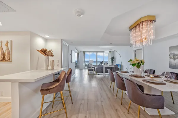 a view of a dining room with furniture and wooden floor