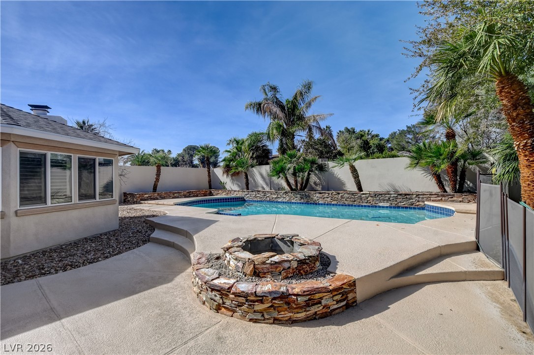 4207 Ridgecrest Drive Las Vegas, NV 89121 - Photo 24 of 27 View of pool with an outdoor fire pit, a fenced backyard, and patio surround