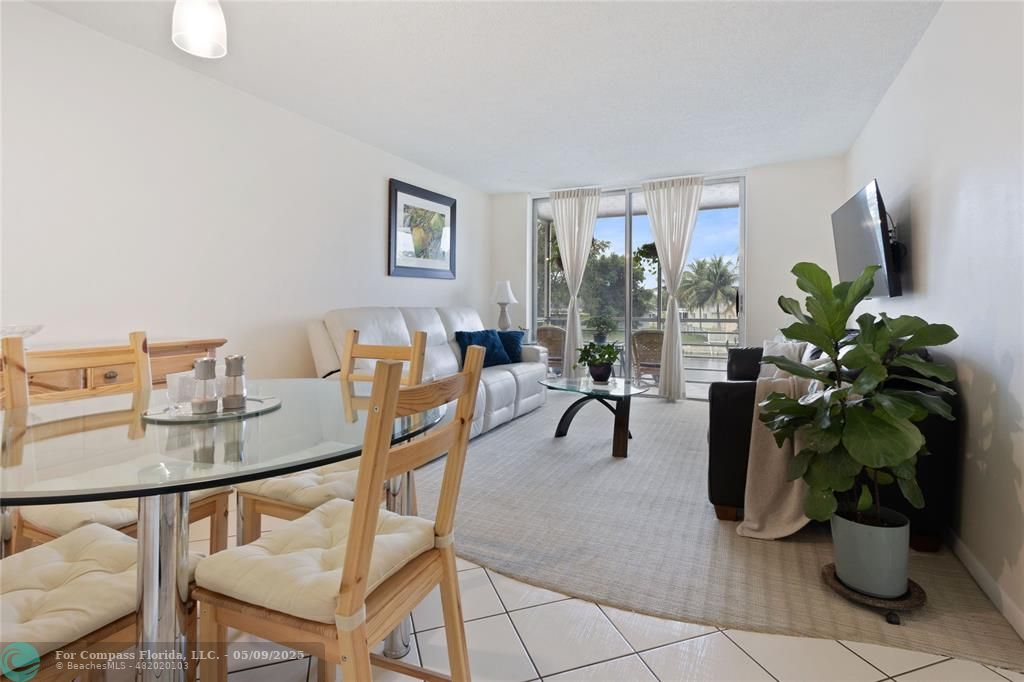 9400 Lime Bay Boulevard, Unit 214 Tamarac, FL 33321 - Photo 2 of 17 a living room with furniture potted plant and a potted plant
