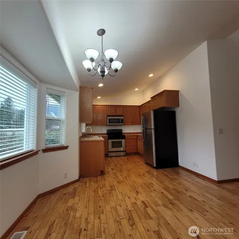 a view of wooden floor and windows in a room