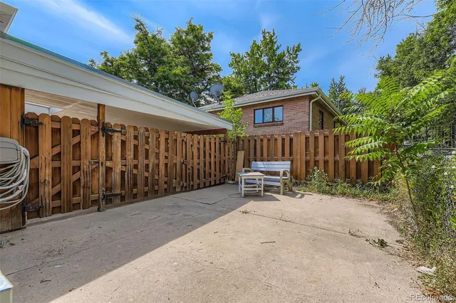 a view of a chair and table in backyard of the house