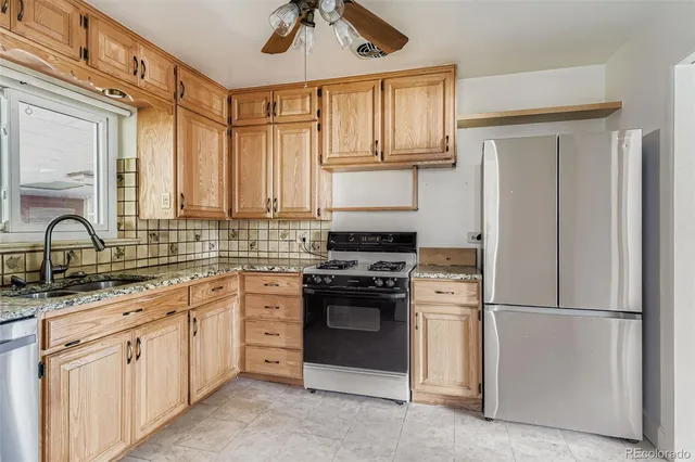 a kitchen with appliances cabinets and a sink