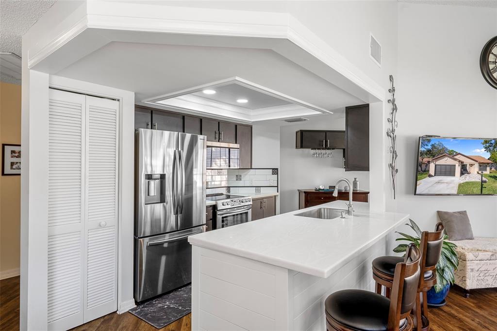 6732 Oak Cluster Circle Spring Hill, FL 34606 - Photo 13 of 65 a kitchen with stainless steel appliances a refrigerator and a stove top oven