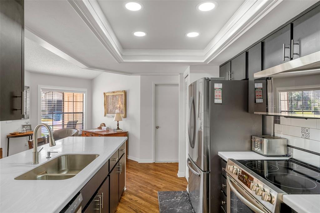 6732 Oak Cluster Circle Spring Hill, FL 34606 - Photo 16 of 65 a kitchen with stainless steel appliances granite countertop a sink stove and refrigerator