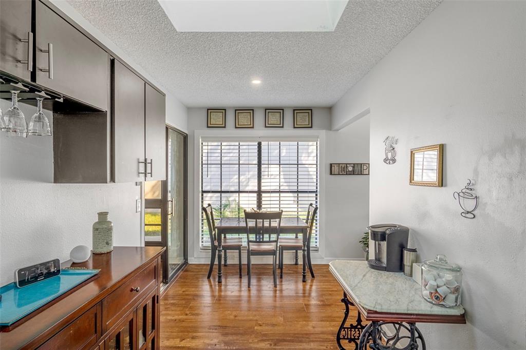 6732 Oak Cluster Circle Spring Hill, FL 34606 - Photo 18 of 65 a view of a dining room with furniture window and wooden floor