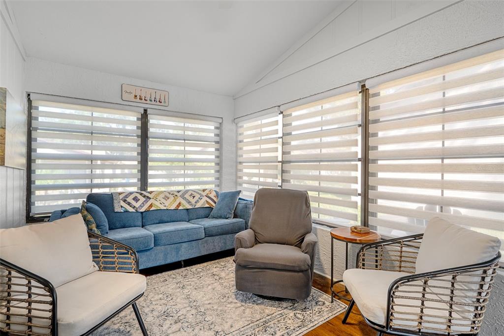 6732 Oak Cluster Circle Spring Hill, FL 34606 - Photo 23 of 65 a living room with furniture and a large window