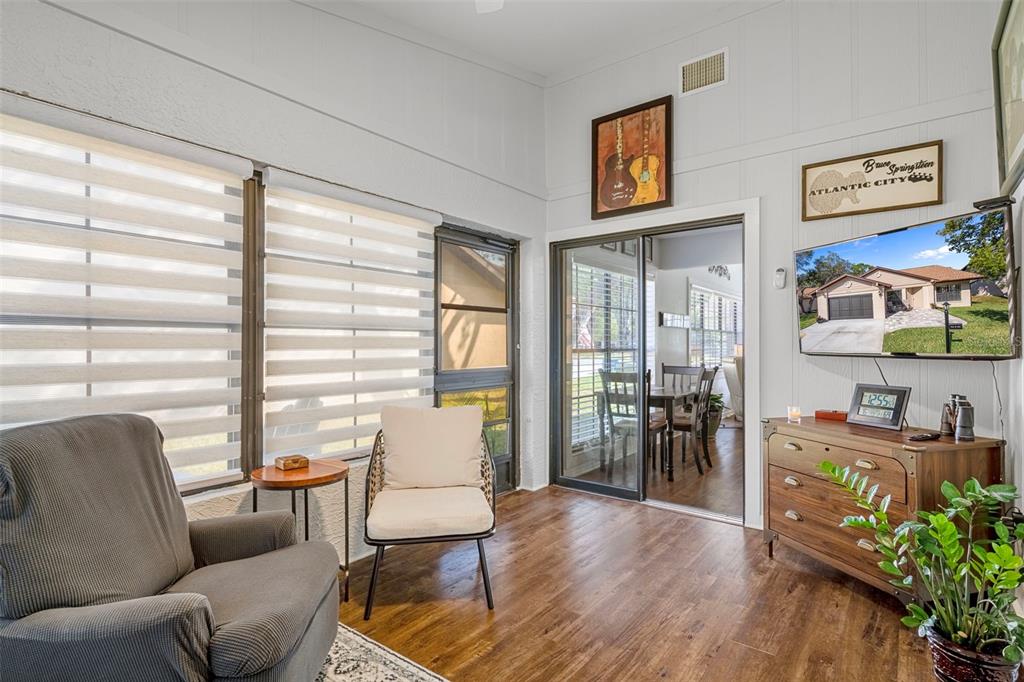6732 Oak Cluster Circle Spring Hill, FL 34606 - Photo 24 of 65 a living room with furniture and a table