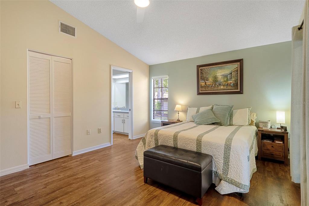 6732 Oak Cluster Circle Spring Hill, FL 34606 - Photo 26 of 65 a bedroom with a bed and wooden floor