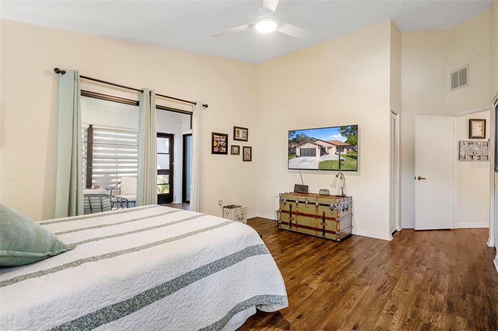 6732 Oak Cluster Circle Spring Hill, FL 34606 - Photo 27 of 65 a bedroom with a bed and wooden floor