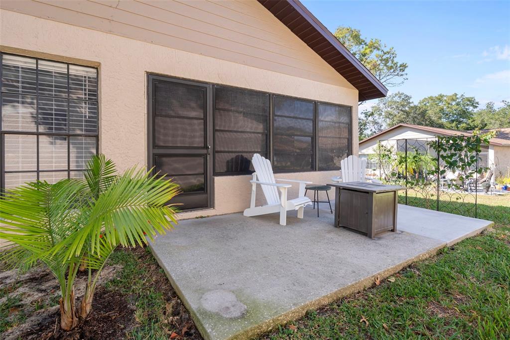 6732 Oak Cluster Circle Spring Hill, FL 34606 - Photo 39 of 65 a view of a chairs and table in patio