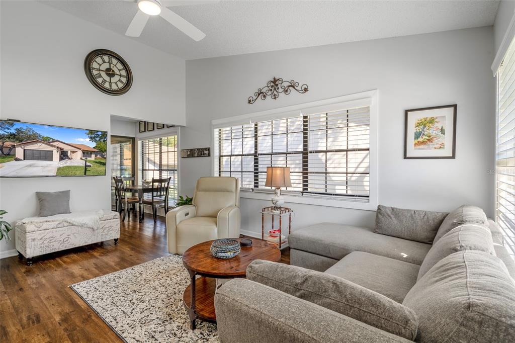 6732 Oak Cluster Circle Spring Hill, FL 34606 - Photo 7 of 65 a living room with furniture and a large window
