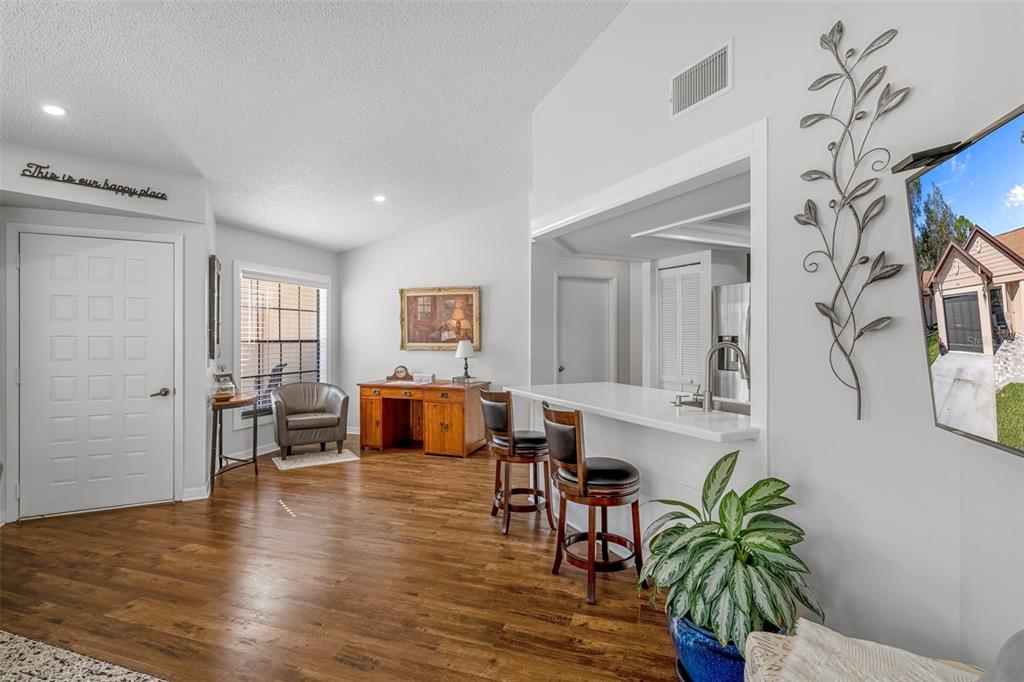 6732 Oak Cluster Circle Spring Hill, FL 34606 - Photo 9 of 65 a living room with furniture and wooden floor