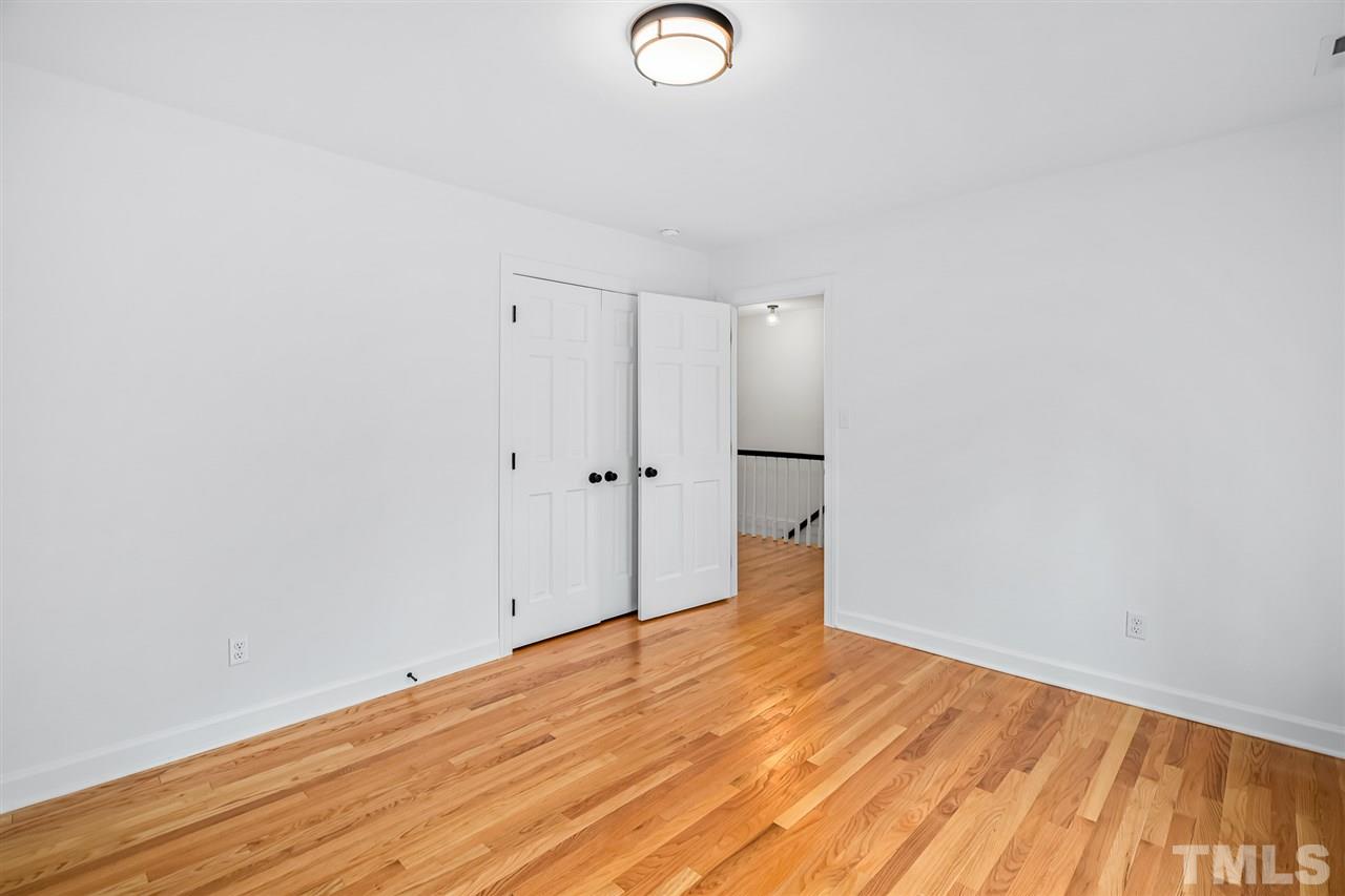 920 East Millbrook Road Raleigh, NC 27609 - Photo 22 of 30 a view of a room with wooden floor and white walls