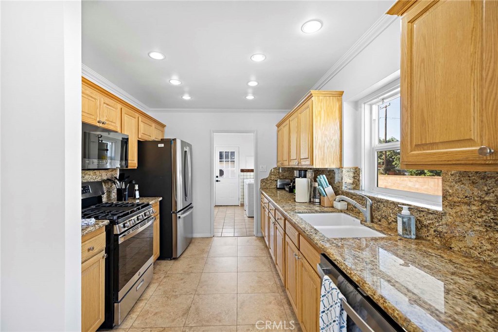 720 East Foothill Boulevard Glendora, CA 91741 - Photo 17 of 37 a kitchen with stainless steel appliances granite countertop sink stove and refrigerator