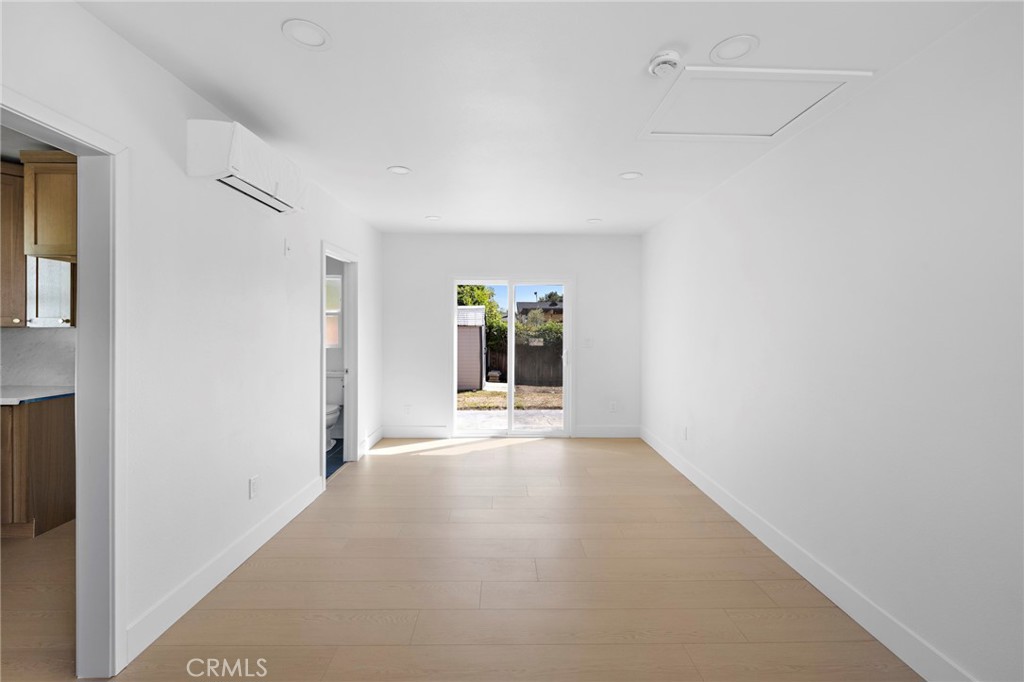 720 East Foothill Boulevard Glendora, CA 91741 - Photo 27 of 37 a view of an empty room with wooden floor and a window