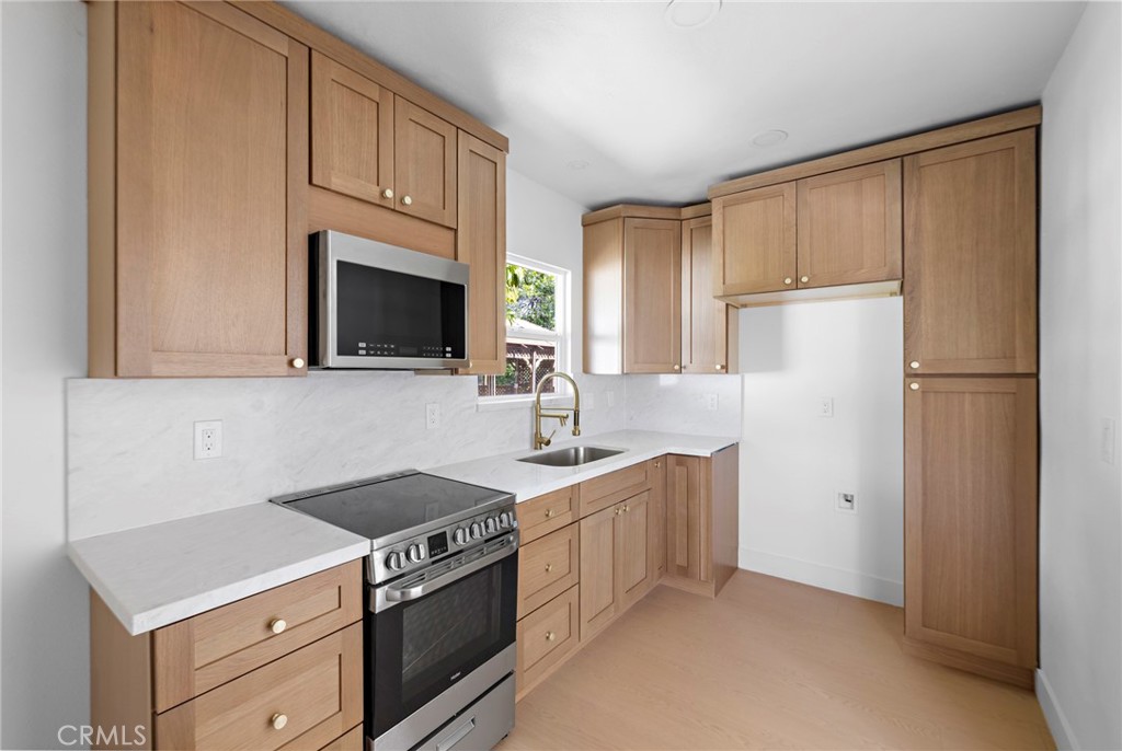 720 East Foothill Boulevard Glendora, CA 91741 - Photo 30 of 37 a kitchen with stainless steel appliances white cabinets and a refrigerator