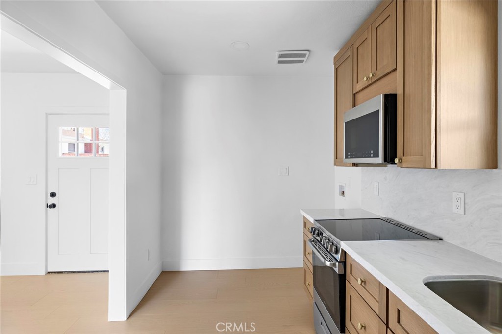 720 East Foothill Boulevard Glendora, CA 91741 - Photo 33 of 37 a kitchen that has a sink and a stove in it