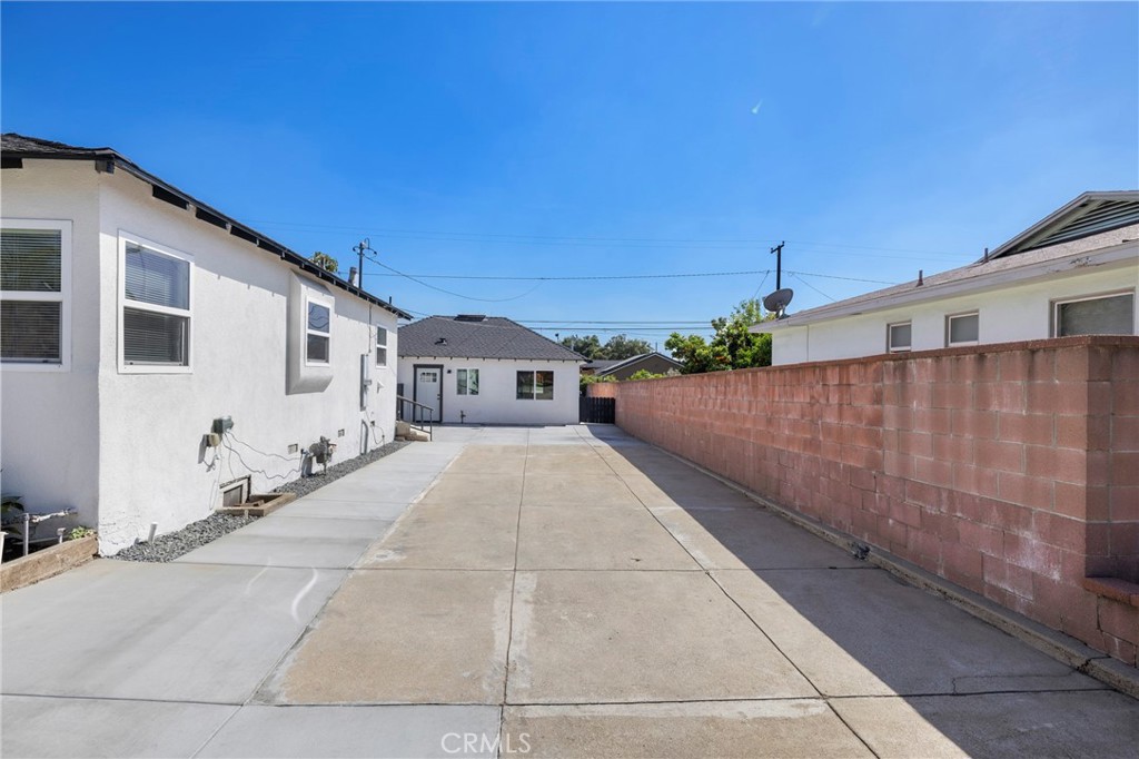 720 East Foothill Boulevard Glendora, CA 91741 - Photo 5 of 37 a front view of a house with a yard and garage