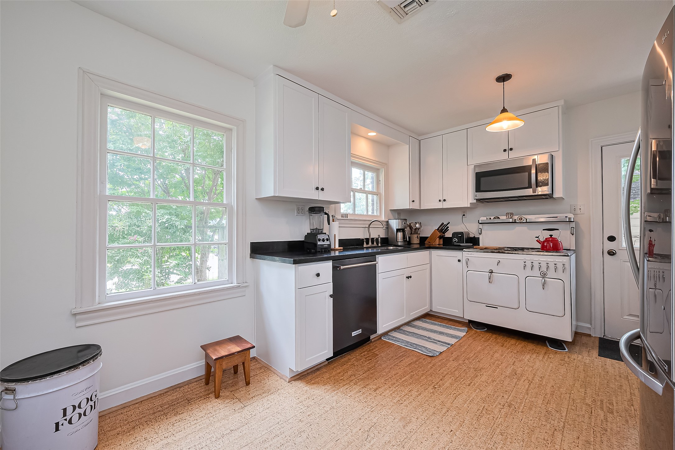 501 Gale Street Houston, TX 77009 - Photo 13 of 49 a kitchen with granite countertop white cabinets and white appliances