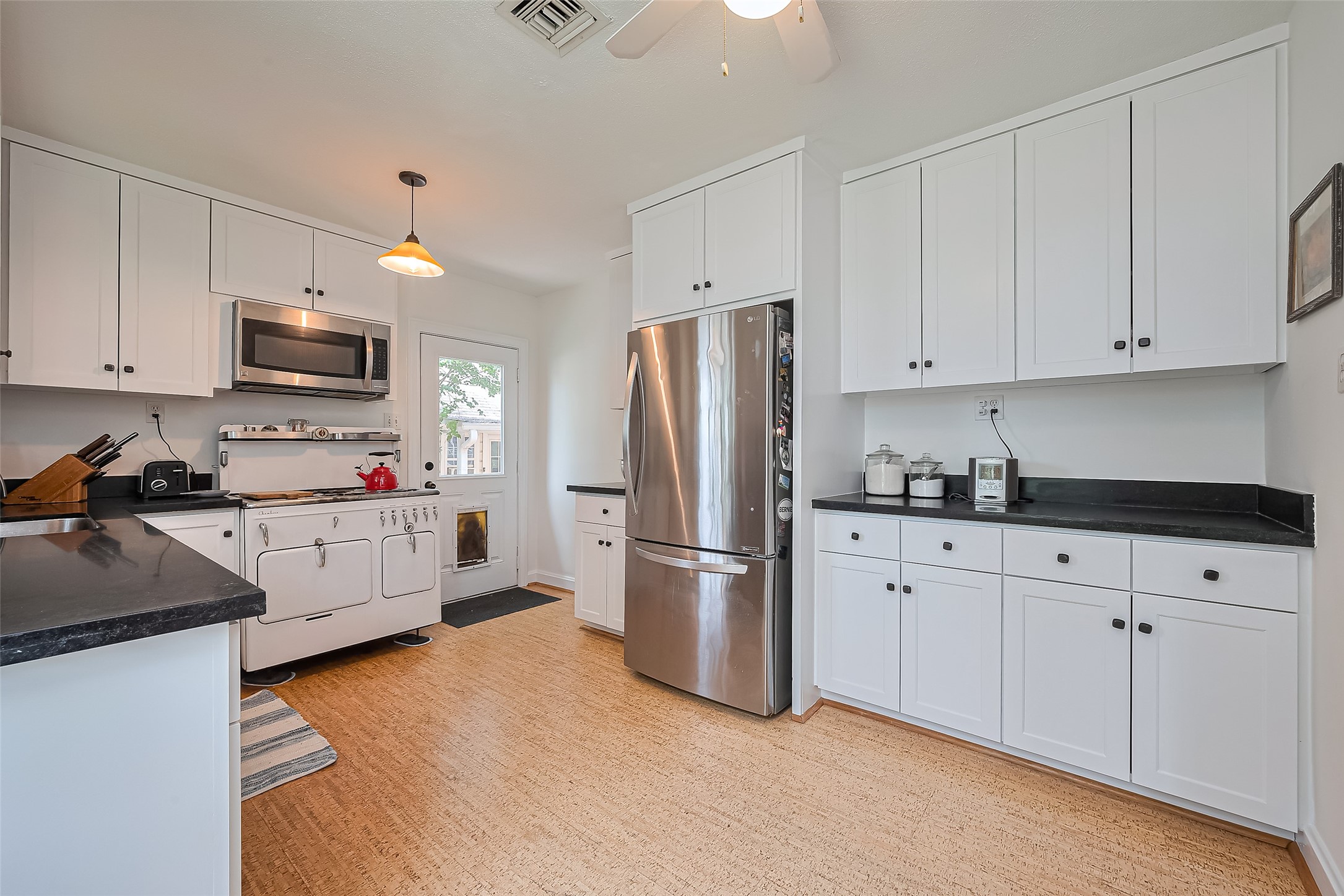 501 Gale Street Houston, TX 77009 - Photo 14 of 49 a kitchen with stainless steel appliances white cabinets and a refrigerator