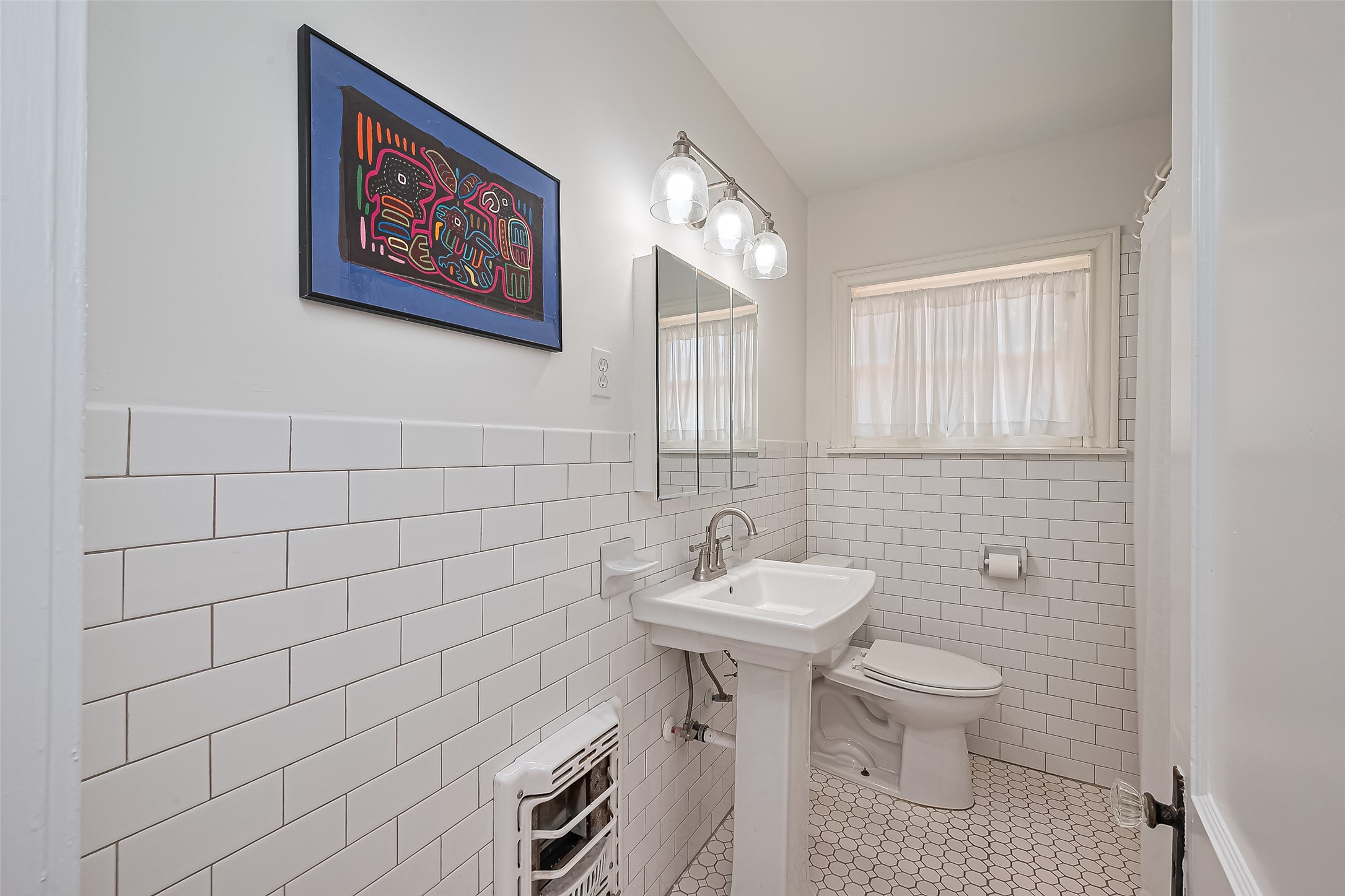 501 Gale Street Houston, TX 77009 - Photo 21 of 49 a bathroom with a toilet sink and mirror