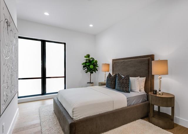 3601 Routh Street, Unit 2E Dallas, TX 75219 - Photo 8 of 14 Bedroom with light wood-style flooring, multiple windows, and recessed lighting