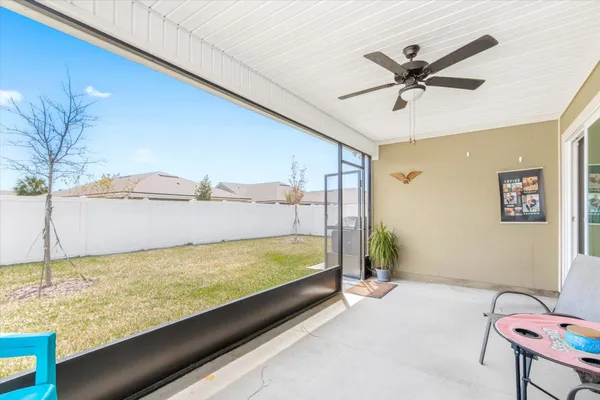 a backyard of a house with table and chairs